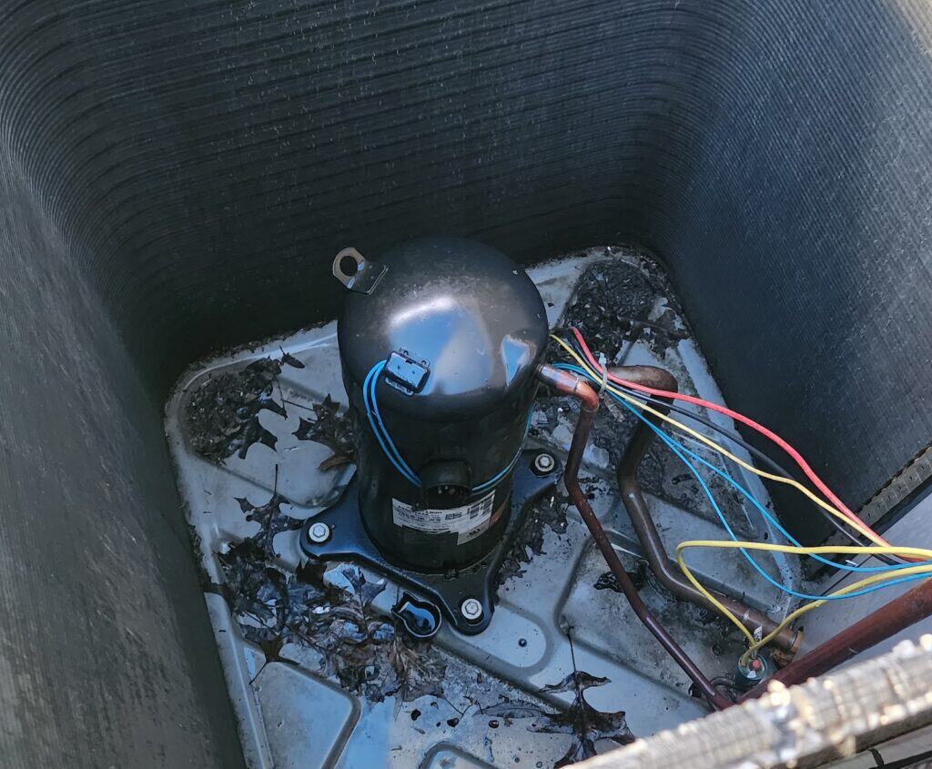 High-efficiency HVAC compressor with wiring inside outdoor unit for residential cooling system.