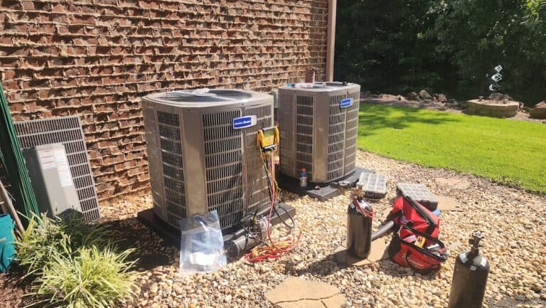 A professional HVAC technician services heat pumps in Birmingham, AL.