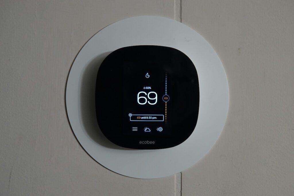 Smart thermostat showing current temperature and settings in a Birmingham residence.