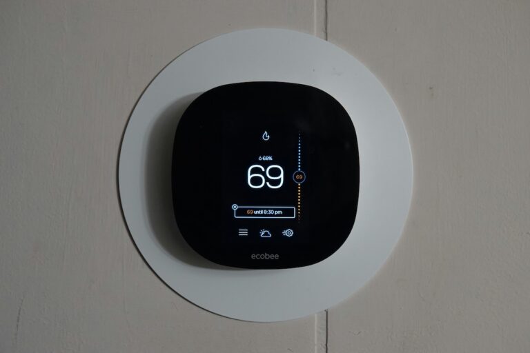 Smart thermostat showing current temperature and settings in a Birmingham residence.